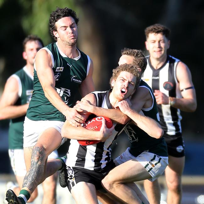 Euroa’s Nathan Stewart is gang tackled by Echuca pair Bailey Gray and Corbin Anderson.