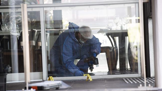 Police gather evidence at the restaurant. (News Corp/Attila Csaszar)