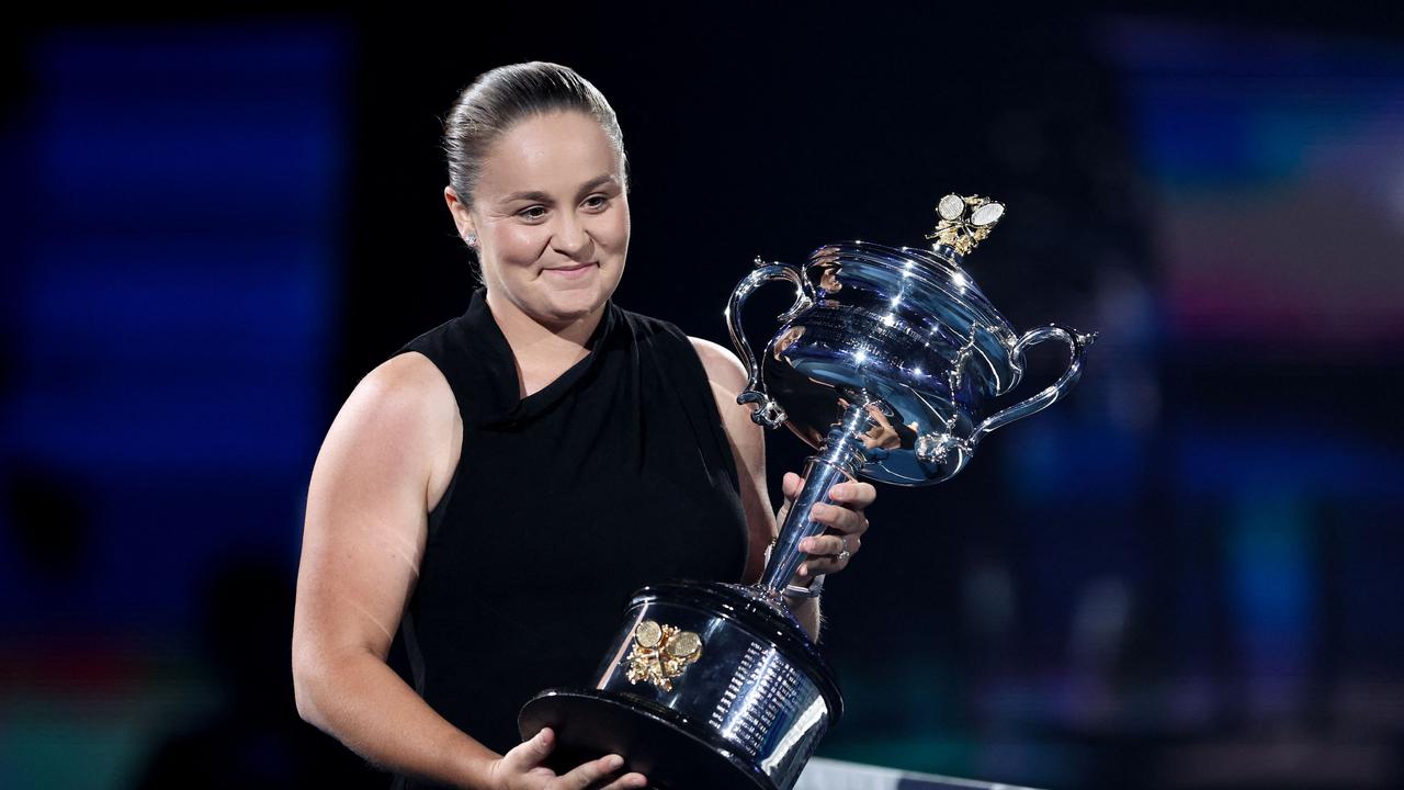 Retired former world number one Australian tennis player Ashleigh Barty carries the Daphne Akhurst Memorial Cup. Photo by Martin KEEP / AFP.