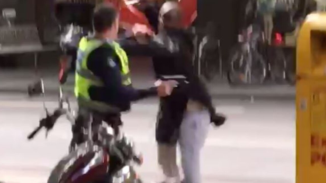 A police officer coming face-to-face with terrorist Hassan Shire Ali on Bourke St.