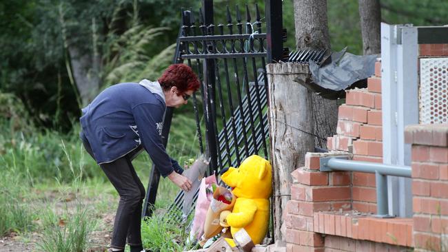 Locals pay their respects at the scene on Warne St in Wellington. Picture: Jonathan Ng