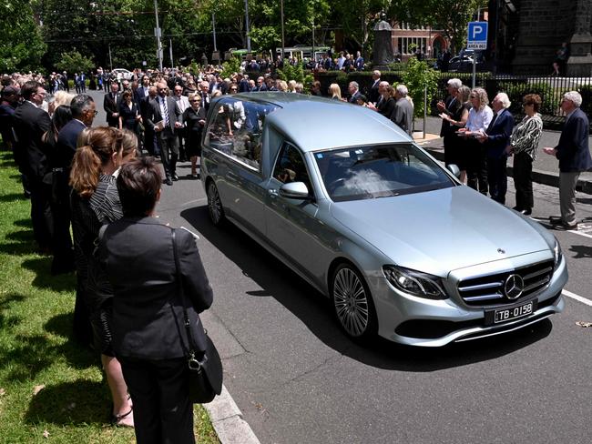 Mourners pay their respects as the Neale Fraser’s casket leaves St Patrick's Cathedral. Picture: AFP