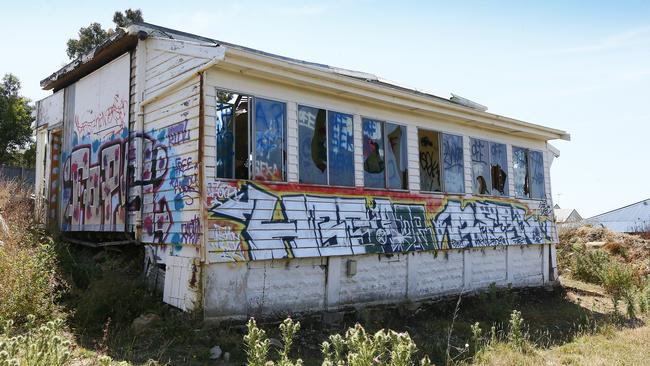 Darko Krajinovic is the owner / developer of 55 Mount Stuart Road and has been charged with the illegal demolition of the original weatherboard house and surrounding garden. Pictured is the site showing graffiti on what is left. Picture: MATT THOMPSON