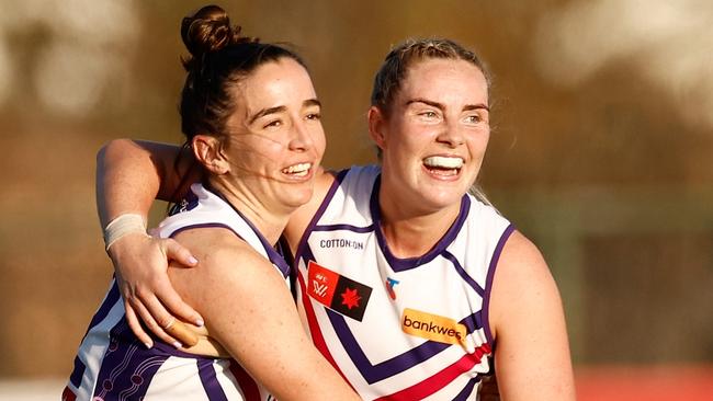 MELBOURNE, AUSTRALIA - AUGUST 31: Laura Pugh (left) and Aisling McCarthy of the Dockers celebrate during the 2024 AFLW Round 01 match between the Essendon Bombers and the Fremantle Dockers at Windy Hill on August 31, 2024 in Melbourne, Australia. (Photo by Michael Willson/AFL Photos via Getty Images)