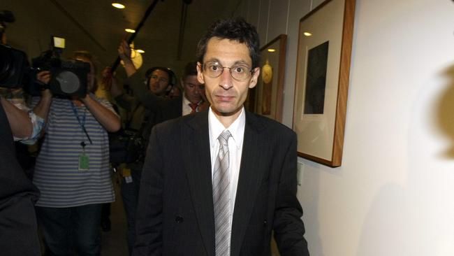 Principal Advisor Financial Systems Division of the Department of Treasury Godwin Grech surrounded by media leaving Parliament House after appearing at the public hearing into car dealership financing guarantee appropriation bill 2009 in Canberra, ACT, 22 Jun 2009.