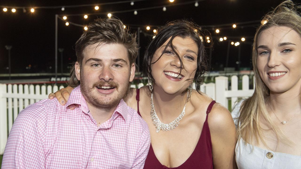 (from left) Mitchell Johnson, Renee Hanrahan and Kaitlyn Schwerin. New Year's eve at King of the Mountain race day, Clifford Park race course. Saturday, December 31, 2022. Picture: Nev Madsen.