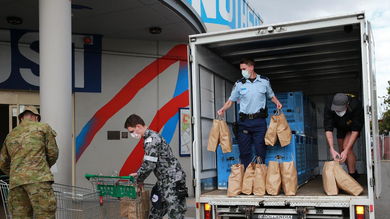 The soldiers carried food shipments off trucks in southwest Sydney alongside NSW Police officers. Picture: NCA NewsWire / Dylan Coker