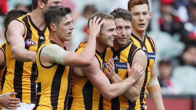 Tom Mitchell is congratulated by teammates after kicking a goal. Picture: Michael Klein