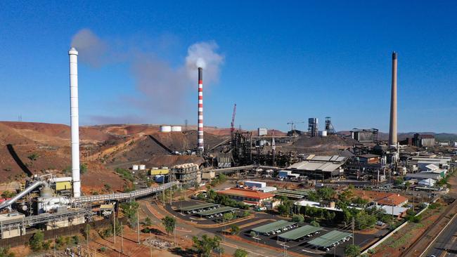 Mount Isa Mines: (L-R) The white smokestack is part acid plant which reprocesses sulphur dioxide into fertiliser, the 'candy stripe' is the copper stack, and the beige is the lead/zinc stack.