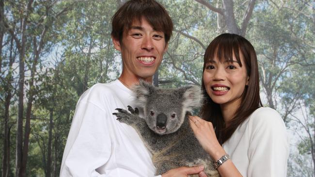 Gold Coast Airport Marathon Japanese runners Takuya Noguchi (winner mens marathon) and wife Risa Takenaka (third womens marathon) with Coen the Koala. Picture Glenn Hampson