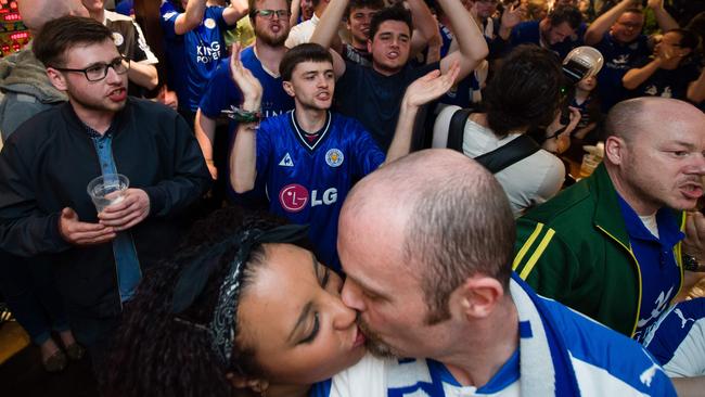 Leicester City football fans react after Leicester scored.