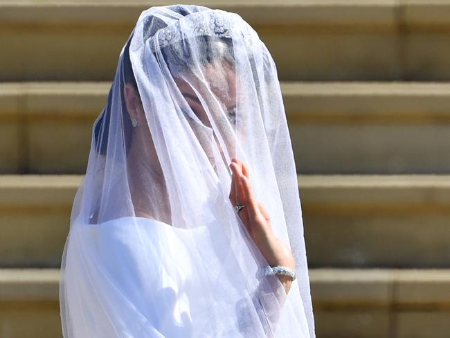 Meghan waves on the steps. Picture: AFP/Ben Stansall