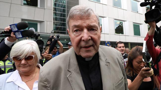 Cardinal George Pell (C) leaves the County Court of Victoria court after prosecutors decided not to proceed with a second trial on alleged historical child sexual offences in Melbourne on February 26, 2019. - Australian Cardinal George Pell, who helped elect popes and ran the Vatican's finances, has been found guilty of sexually assaulting two choirboys, becoming the most senior Catholic cleric ever convicted of child sex crimes. (Photo by Asanka Brendon Ratnayake / AFP)