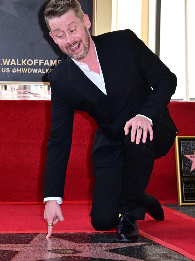 Macaulay Culkin points to his newly unveiled Hollywood Walk of Fame Star. Picture: Frederic J. BROWN / AFP