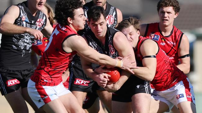 Port Adelaide’s Josh Sinn is tackled by West Adelaide’s Owen Mulady (left) at Alberton Oval last season. Picture: David Mariuz/SANFL