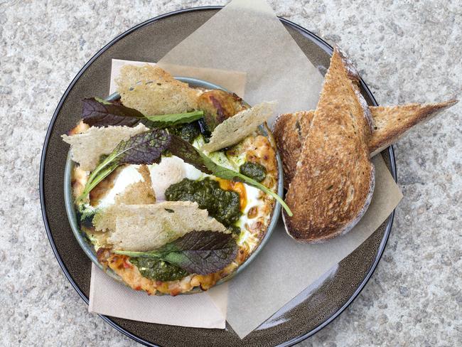 Baked hens eggs, Tuscan white beans and black cabbage. Picture: Sarah Matray