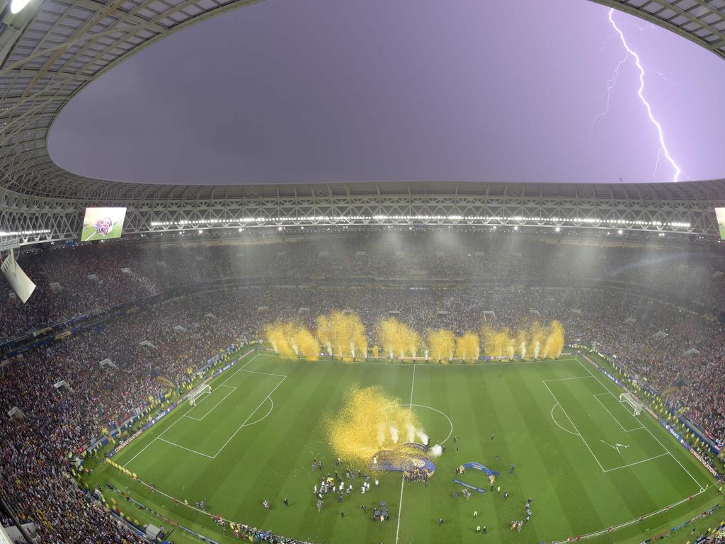 Lightning strikes as France players celebrate after the Russia 2018 World Cup final football match between France and Croatia at the Luzhniki Stadium in Moscow on July 15, 2018. France won the World Cup for the second time in their history after beating Croatia 4-2 in the final in Moscow's Luzhniki Stadium on Sunday. / AFP PHOTO / François-Xavier MARIT