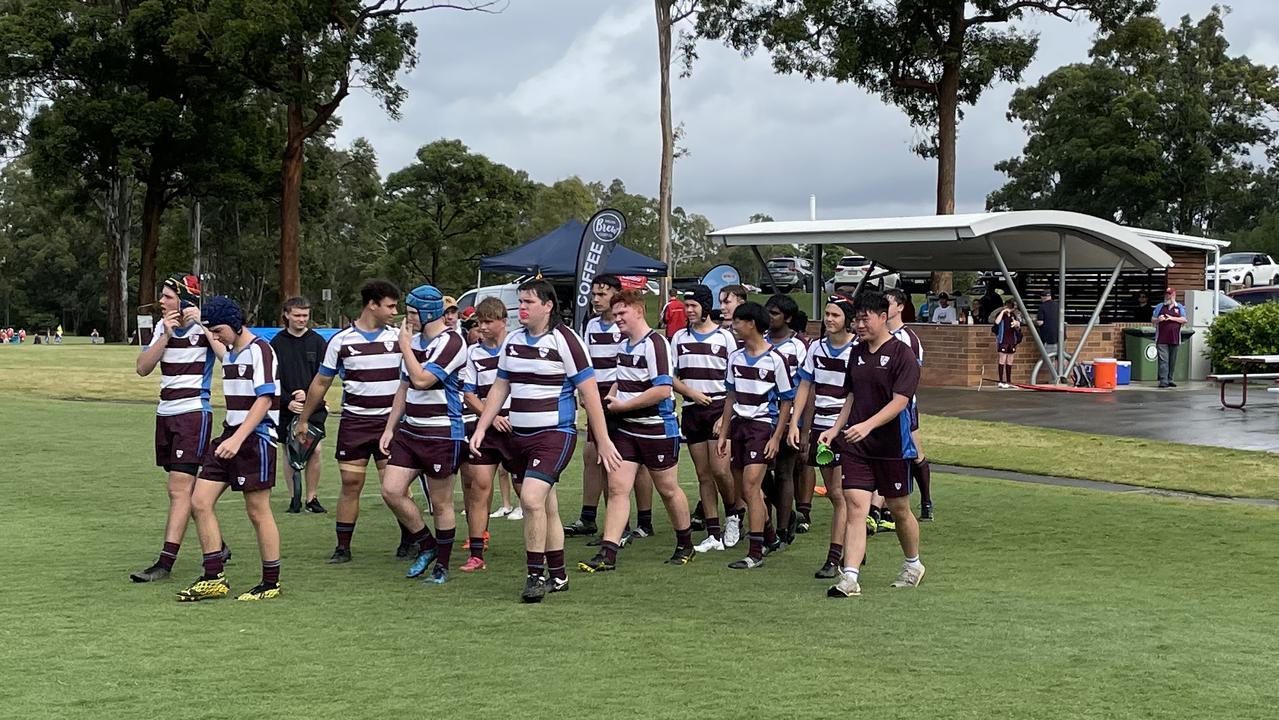 John Paul College players prepare for the match.