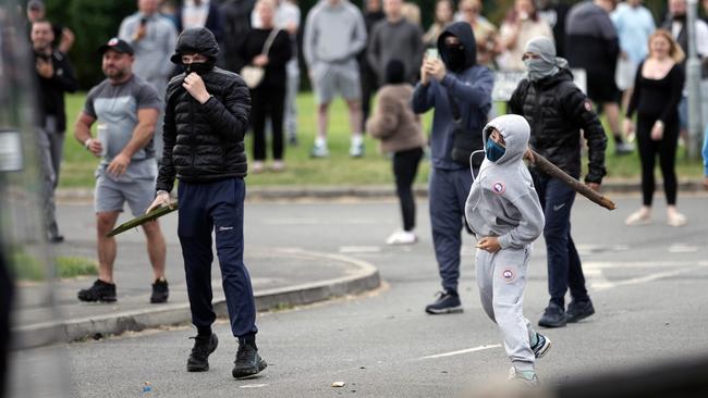 Anti-migration protesters throw objects toward the police in Rotherham. Picture: Getty Images