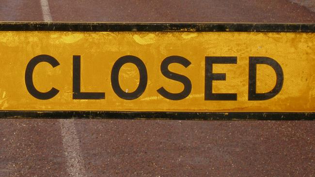 Road closed sign on flooded road at Coober Pedy following heavy rain storm in SA 20 Jan 2007. flood flooding