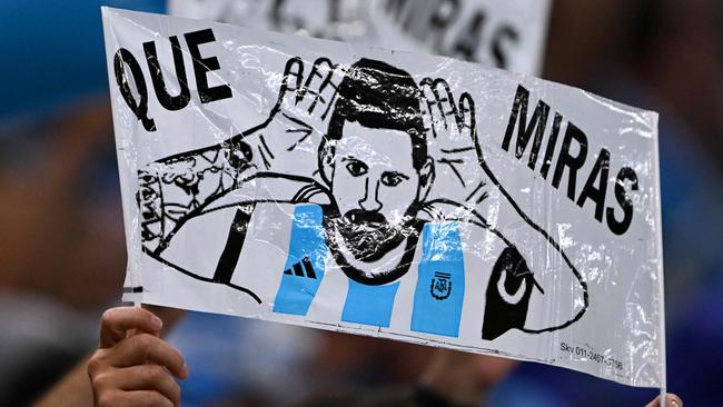 An Argentina supporter holds up a drawing depicting Lionel Messi.