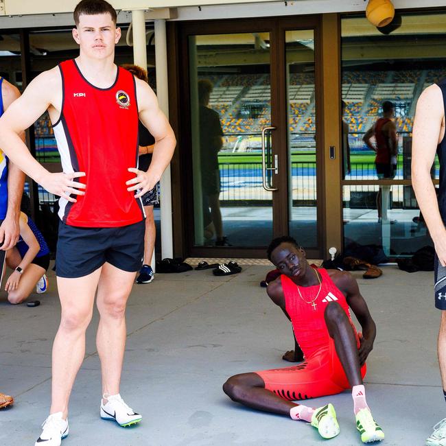 Australian sprinter Gout Gout (C) prepares for the 100m heat.