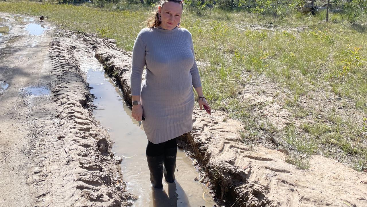 While Mary Allen’s car has been bogged on the unformed part of Richards Road, here she shows the deep ditch left over from when another vehicle was bogged not too long ago.