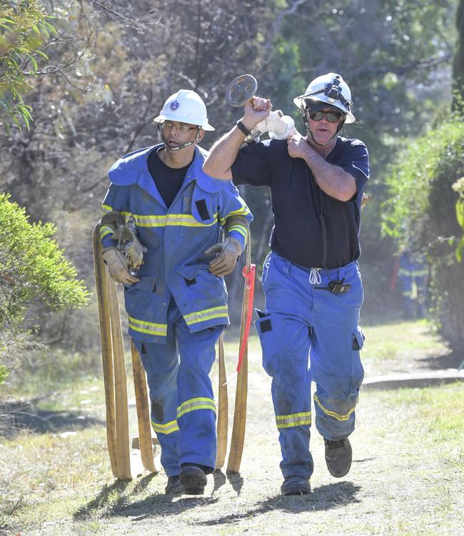 Mr Mayorga and Pat Collins dragging hoses Picture: AAP Image/Simon Bullard