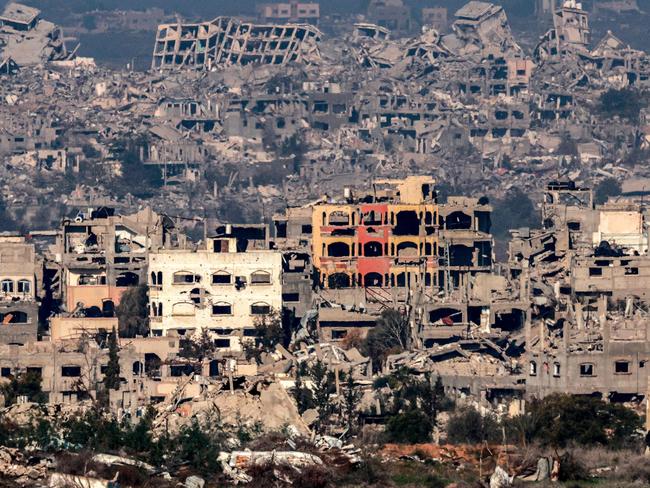 TOPSHOT - This picture taken from the Israeli side of the border with the Gaza Strip shows destroyed buildings in the northern Gaza Strip on January 13, 2025 amid the ongoing war between Israel and Hamas. (Photo by Menahem KAHANA / AFP)