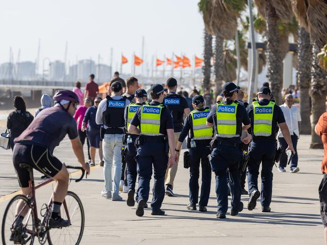 Police patrol the beach and streets at St Kilda. Picture: Jason Edwards