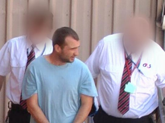 Michael Paul Benfell is led into the Adelaide Magistrates Court following his arrest last year. Picture: Nine News