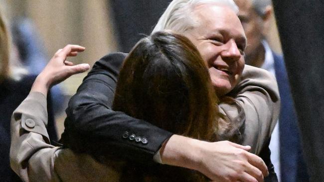 WikiLeaks founder Julian Assange hugs his wife Stella after arriving at Canberra Airport on Wednesday night. Picture: AFP