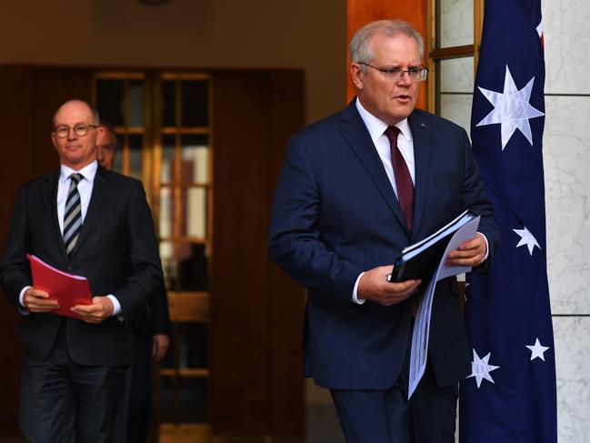 Prime Minister Scott Morrison arrives for a news conference in the prime minister's courtyard on with Acting Chief Medical Officer Paul Kelly. Picture: Sam Mooy/Getty Images