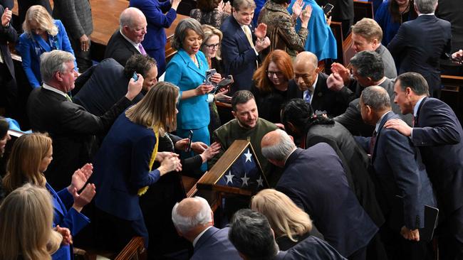 Volodymyr Zelensky is mobbed by members of the US congress after delivering his adress to the joint sitting on Wednesday. Picture: AFP