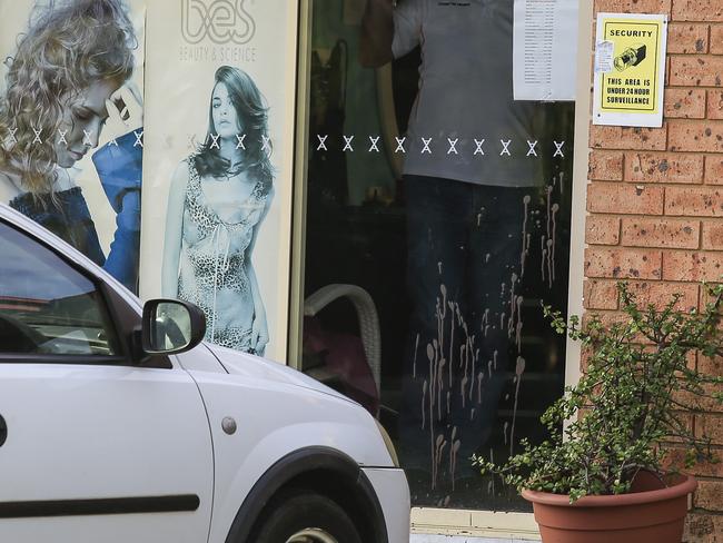 Blood sprayed on the glass door of the hairdressing salon where the attacker bashed his head. Picture: Dylan Robinson