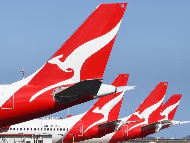 SYDNEY, AUSTRALIA - AUGUST 18: The tail fins of Qantas aircraft parked at Sydney's Kingsford Smith International Airport on August 18, 2021 in Sydney, Australia. Qantas Group has announced COVID-19 vaccinations will be mandatory for all 22,000 staff members. Frontline employees Ã¢â¬â including cabin crew, pilots and airport workers Ã¢â¬â will need to be fully vaccinated by November 15 and the remainder of employees by March 31. There will be exemptions for those who are unable to be vaccinated for documented medical reasons, which is expected to be very rare. (Photo by James D. Morgan/Getty Images)