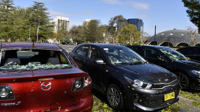 Hail damaged cars are seen parked outside the National Film and Sound Archive of Australia in Canberra. Picture: AAP Image/Mick Tsikas.