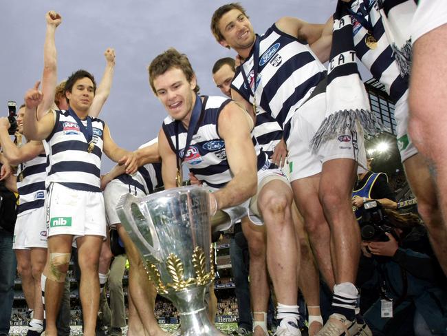 2007 Grand Final. Geelong v Port Adelaide. MCG. Cats player Cameron Mooney places the premiership cup in the middle of celebrating Cats players.