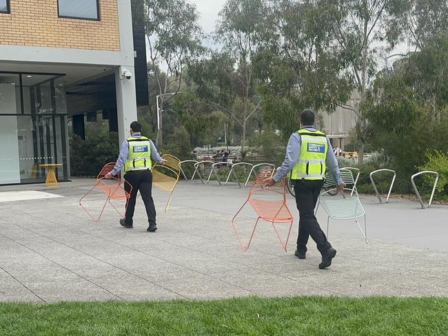 Monash University security remove chairs that had been used as a barricade.