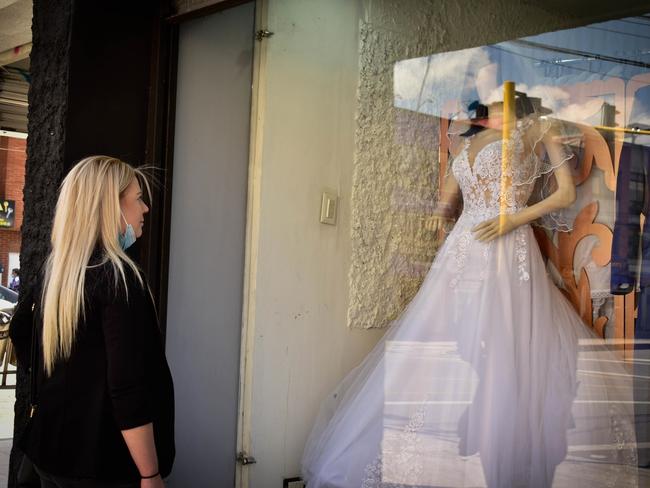 Cassie Sainsbury admires a wedding dress in Cundinamarca, Bogota, ahead of her wedding to girlfriend Tatiana. Picture: Backgrid