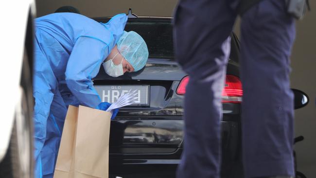 Police with evidence bags at the scene. Picture: Glenn Hampson.