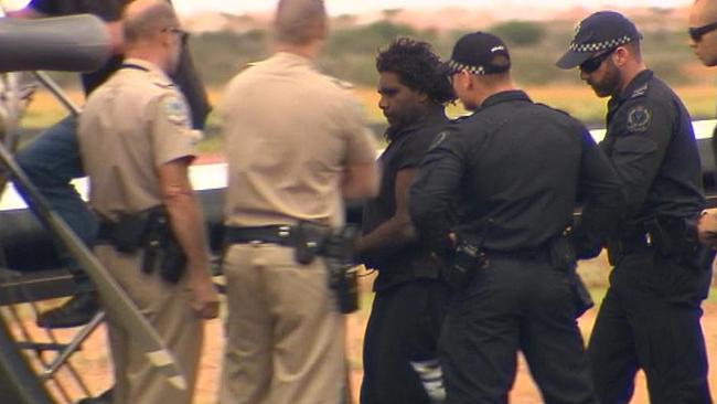 Dudley Davey is taken into custody after the murder of outback nurse Gayle Woodford in 2016. Photo: Seven News Adelaide.