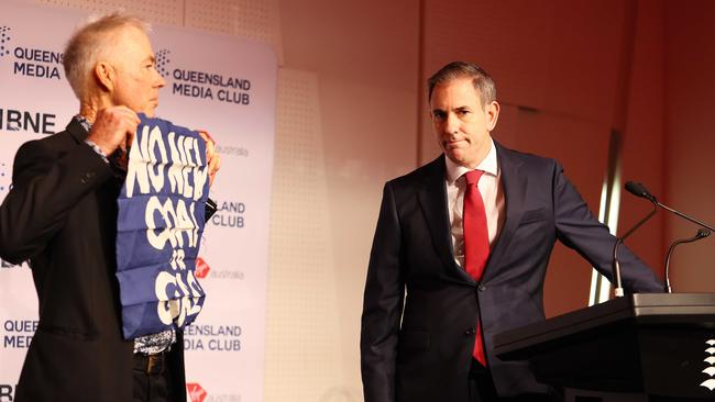 An anti-coal protester interrupts Treasurer Jim Chalmers' pre-budget speech in Brisbane. Picture: Tertius Pickard/NewsWire