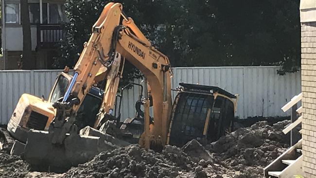 Earth moving machinery bogged at a Barralong Road construction site at Erina.