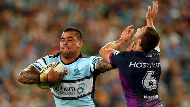 Andrew Fifita attempts to bust the tackle of Storm's Blake Green. Picture: Gregg Porteous