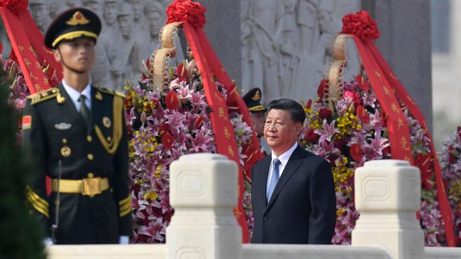 China's President Xi Jinping walks around the Monument to the People's Heroes on Tiananmen Square during a wreath-laying ceremony marking Martyrs' Day at Tiananmen Square in Beijing.