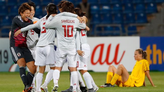 Japan players celebrate after winning the AFC Women's Asian Cup Finals match against Australia at the King Abdullah II Stadium in the Jordanian capital Amman.