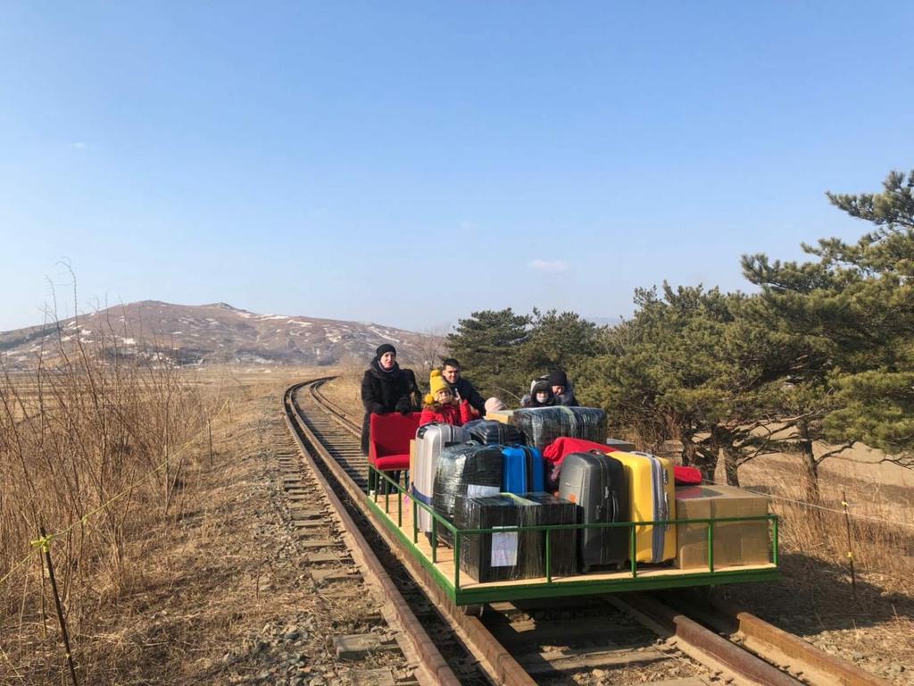 Embassy worker Vladislav Sorokin pushed his family along the tracks for about a kilometre. Picture: Russian Foreign Ministry/AFP