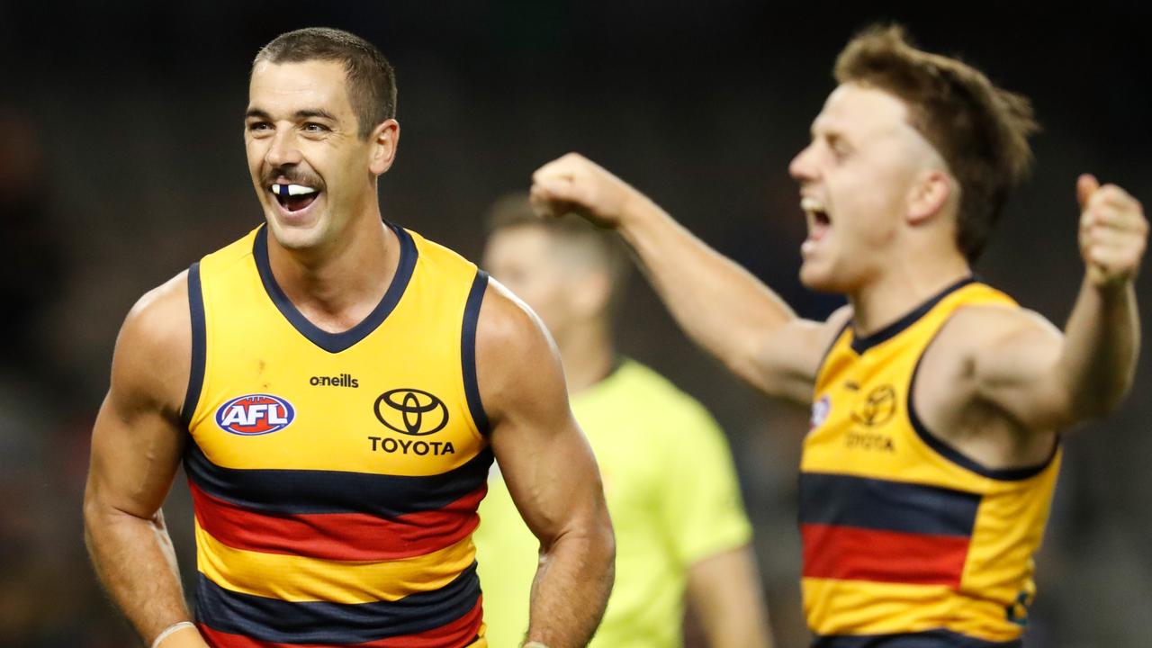 Taylor Walker and James Rowe celebrate one of the Crows’ final-quarter goals. Picture: Michael Willson/AFL Photos via Getty Images