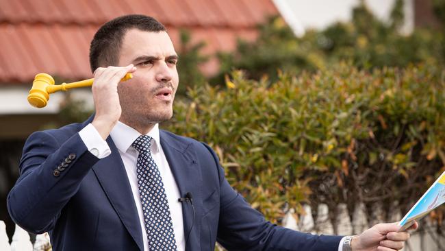 Auctioneer Perry Edmondson-Clark brings the gavel down on a sale. Rising property prices is helping bolster the number of homes being offered under the hammer. Picture: Julian Andrews